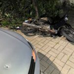 Carro com marca de tiro; Moto caída no chão